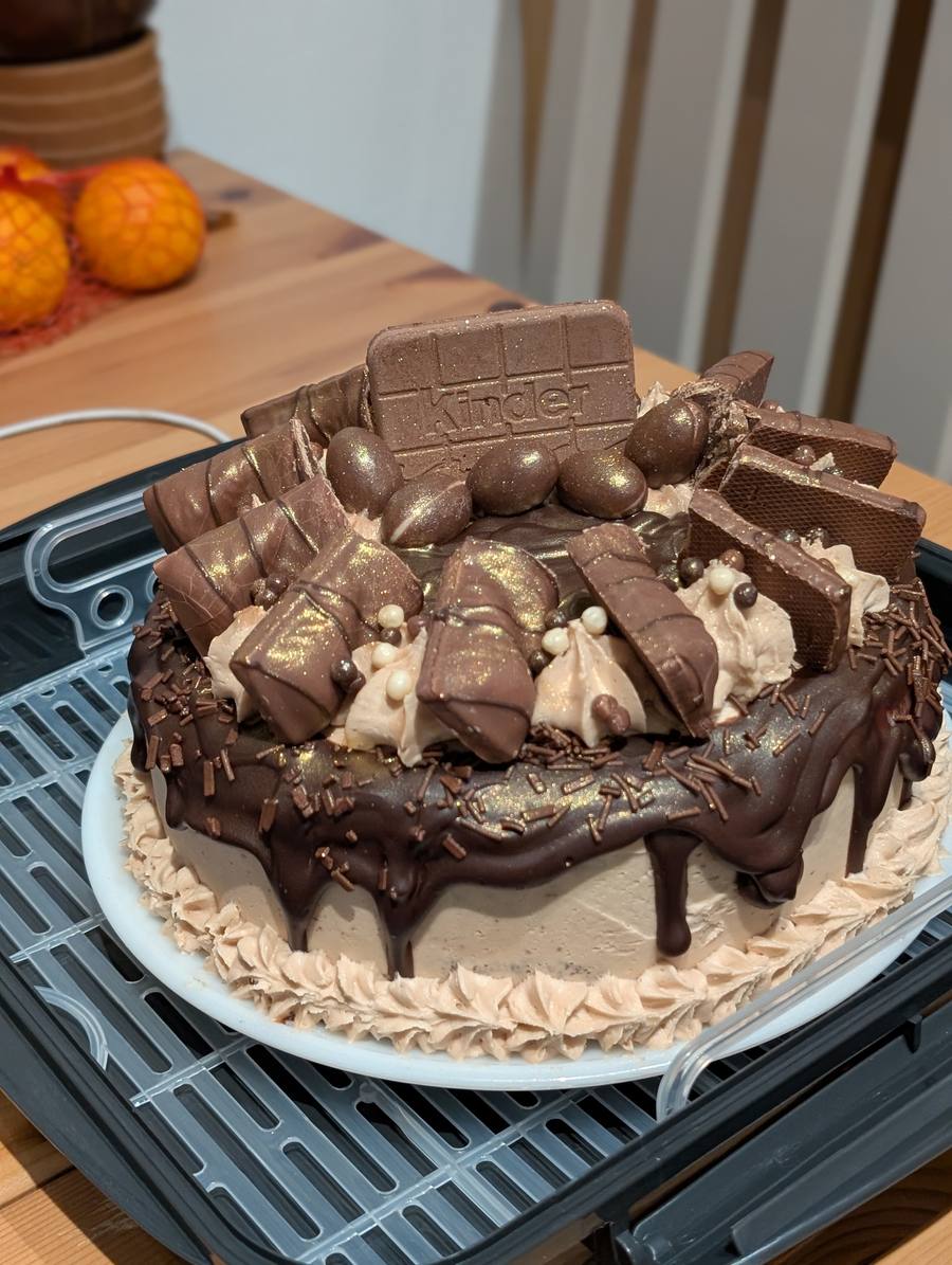 Chocolate drip cake finished with Kinder bars, chocolate eggs and a chocolate ganache drip